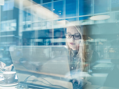 Office worker behind window with film for UV protection