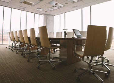 tinted office windows showing conference room with furniture